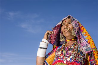 Old woman belonging to the local tribe of Lambani wearing the traditional colorful dress