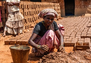 Indian woman producing adobe bricks