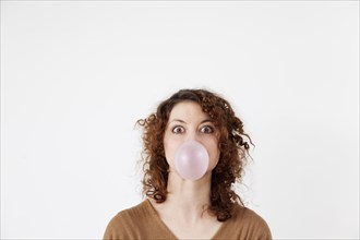 Young woman blowing a chewing gum bubble