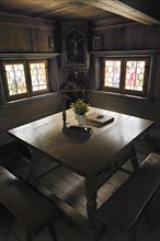 Herrgottswinkel prayer niche with a table and benches in Markus Wasmeier Farm and Winter Sports Museum