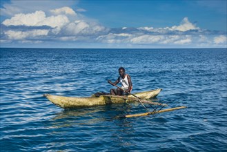 Man in an outrigger boat