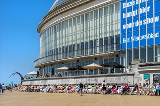 People sunbathing in front of the Oostende Casino