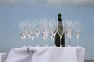 Bar table with champagne glasses and a bottle of champagne