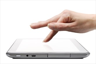 Tablet app being selected by a finger on the touchscreen