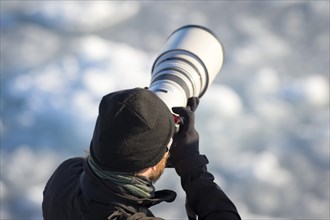 Photographer with a telephoto lens