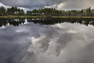 Naveretjarn Lake with dramatic clouds and mirroring