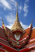 Red roof of a pagoda with an ornate spire