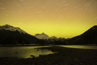 An auroral glow lights up the Chugach Range