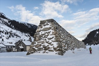 Stone wall as protection against avalanches