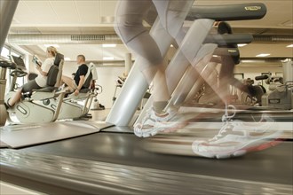 Female athlete exercising on a treadmill in a gym