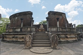 Ruins of a temple with moon stone and a Buddha statue