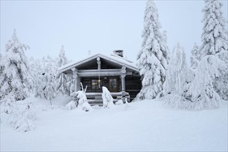Finnish log cabin in the snow-covered landscape