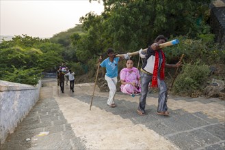 Porters carrying Jain pilgrims up Mount Shatrunjaya