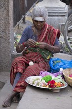 Market woman producing floral decorations