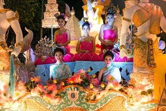 Women in traditional costume travelling on a float