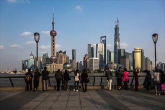 Tourists in front of the Pudong skyline with Oriental Pearl Tower