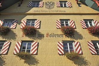 Shingle facade with windows and flower boxes
