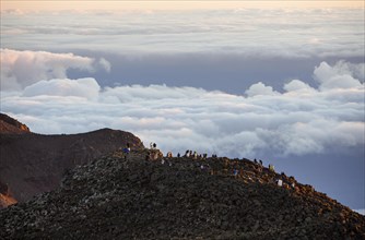 Tourists on the summit of the Haleakala volcano at sunrise