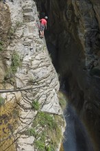 Female climber on the fixed rope route 'Via Farinetta'