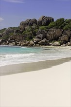 Sandy beach with the rock formations typical for the Seychelles