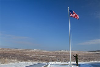 A park ranger raises the flag at the The Flight 93 National Memorial
