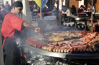 Cook handles giant barbecue at the annual All Saints Market in Cocentaina