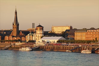 Dusseldorf's historic town centre with St. Lambertus Church and Schlossturm tower on the Rhine promenade