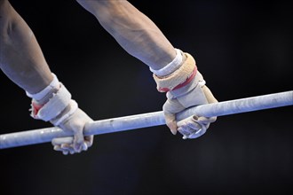 Hands of a gymnast competing on the high bar