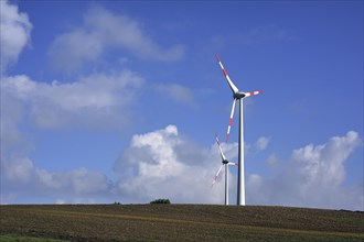 Wind turbines against blue sky