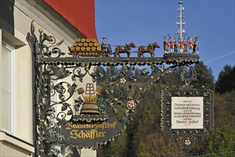 Ornate metal signboard of Brauerei-Gasthof Schaffler