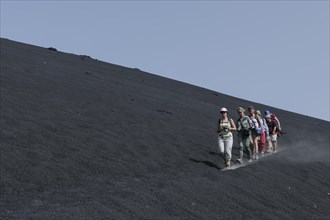 Hikers in the ash field of the Pico do Fogo volcano
