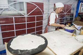 Woman preparing flatbread for a festival