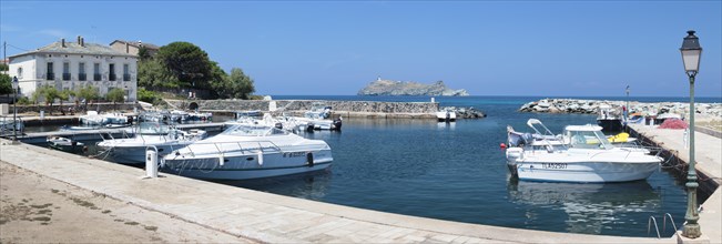 The marina of Macinaggio with the barrier island La Giraglia