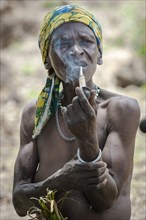 A woman from the Koma people smoking a pipe