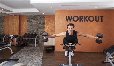 Man doing fitness exercises in a gym