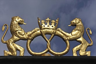 Golden lion sculptures with pretzel