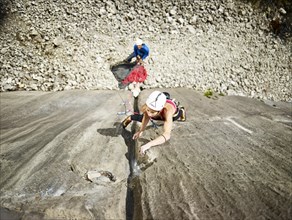 Woman lead climbing a gully