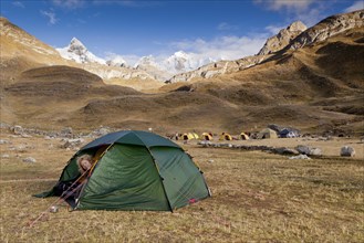 Woman looking out of a tent