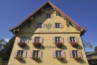 Shingle facade with windows and flower boxes
