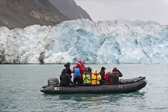 Tourists and guides in an inflatable boat