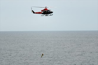 Air-sea rescue service exercise with a frogman on a winch