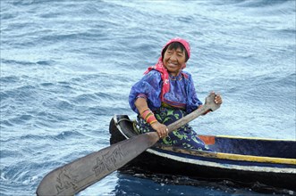 Kuna Indian woman in a dugout canoe