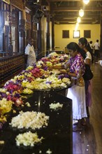 Believers praying in the Temple of the Sacred Tooth Relic