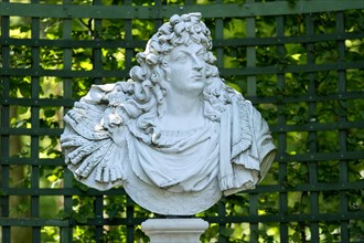 Decorative male bust in the garden archway