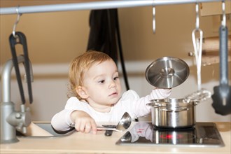 Little girl playing in a children's kitchen