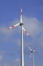 Wind turbines against blue sky