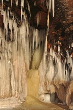 Icicles hanging from red sandstone cliff