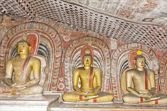 Three statues of Buddha in meditation