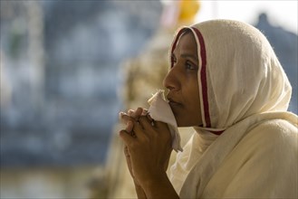 A Jain nun praying at a temple