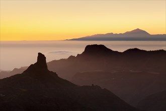Rock formation of Roque Bentayga in front of Tenerife with Mount Teide